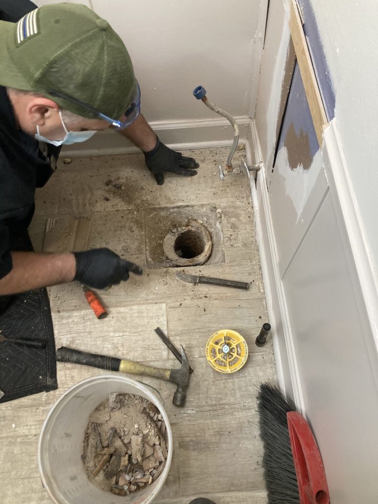 Plumber Repairing Toilet Flange