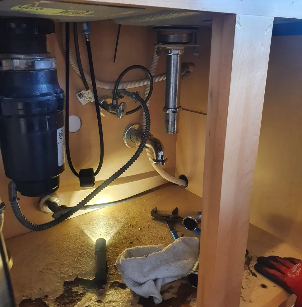 Kitchen Sink Leak Getting Fixed by Rescue Plumbing