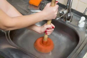 Plunger trying to unclog a clogged drain