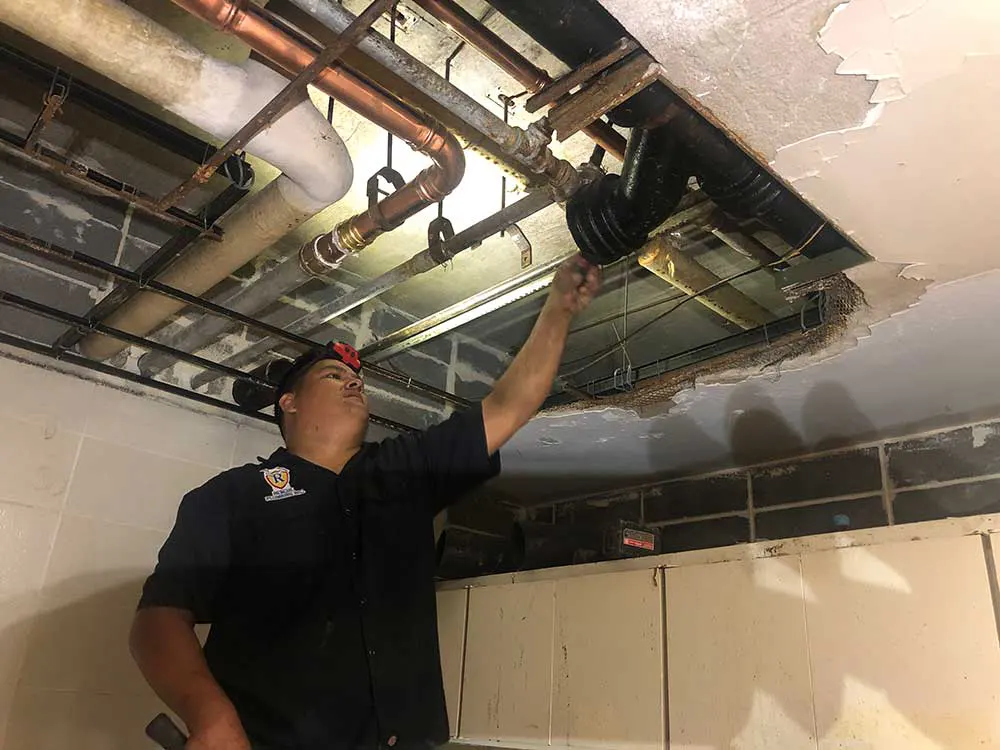 A Rescue Plumber Repairing A Commercial Leak