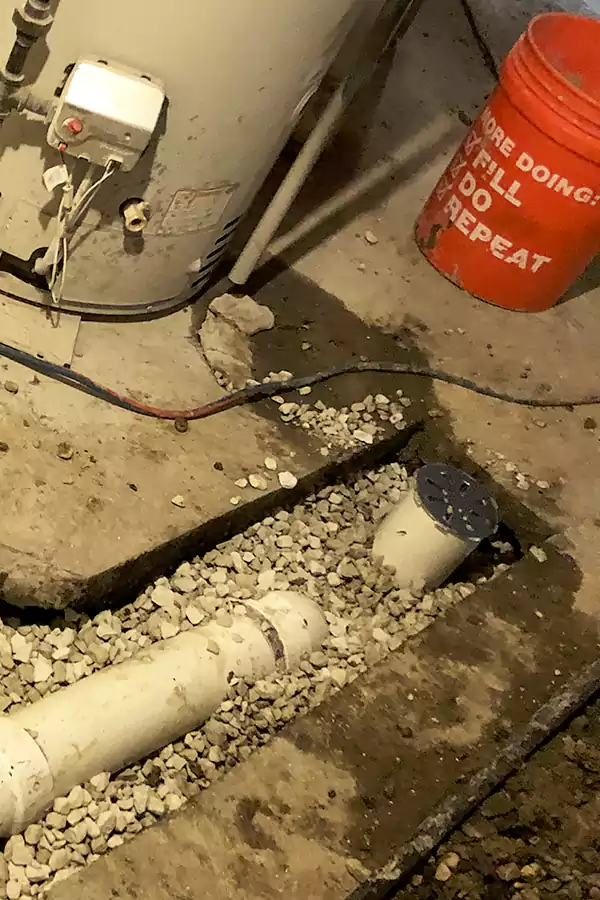 a basement laundry sink connects to where this basement floor drain clog occurred