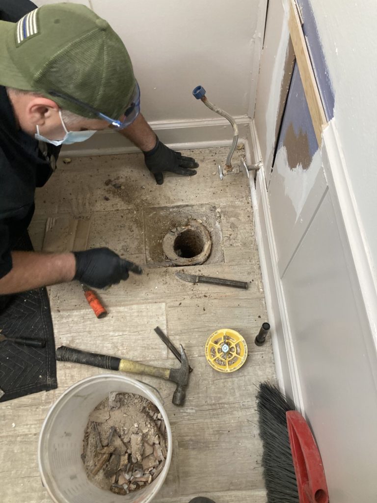Plumber repairing toilet flange