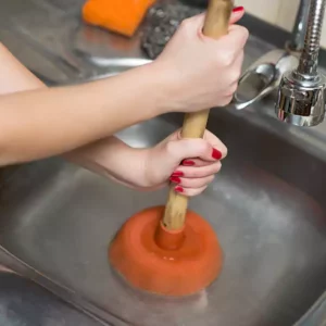 Plunger trying to unclog a clogged drain