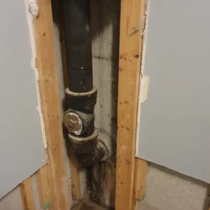Opened wall to access main sewer, plumbing fixtures attached to sewer line