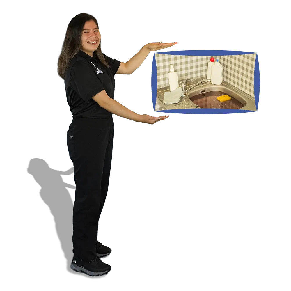 Rescue Plumbing team member showing a clogged kitchen sink