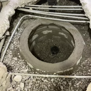 Trained plumber works on sewer cleanout installation