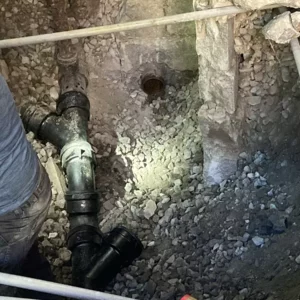 Professional plumber dealing with sewage back up