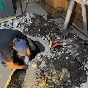 technicians digging in crawl space