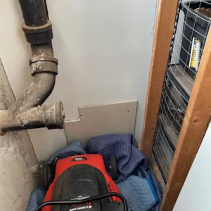 Plumbers perform drain inspection while fixing plumbing issue