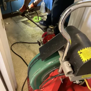 Professional drain machine used in bathroom to discover toilet clog