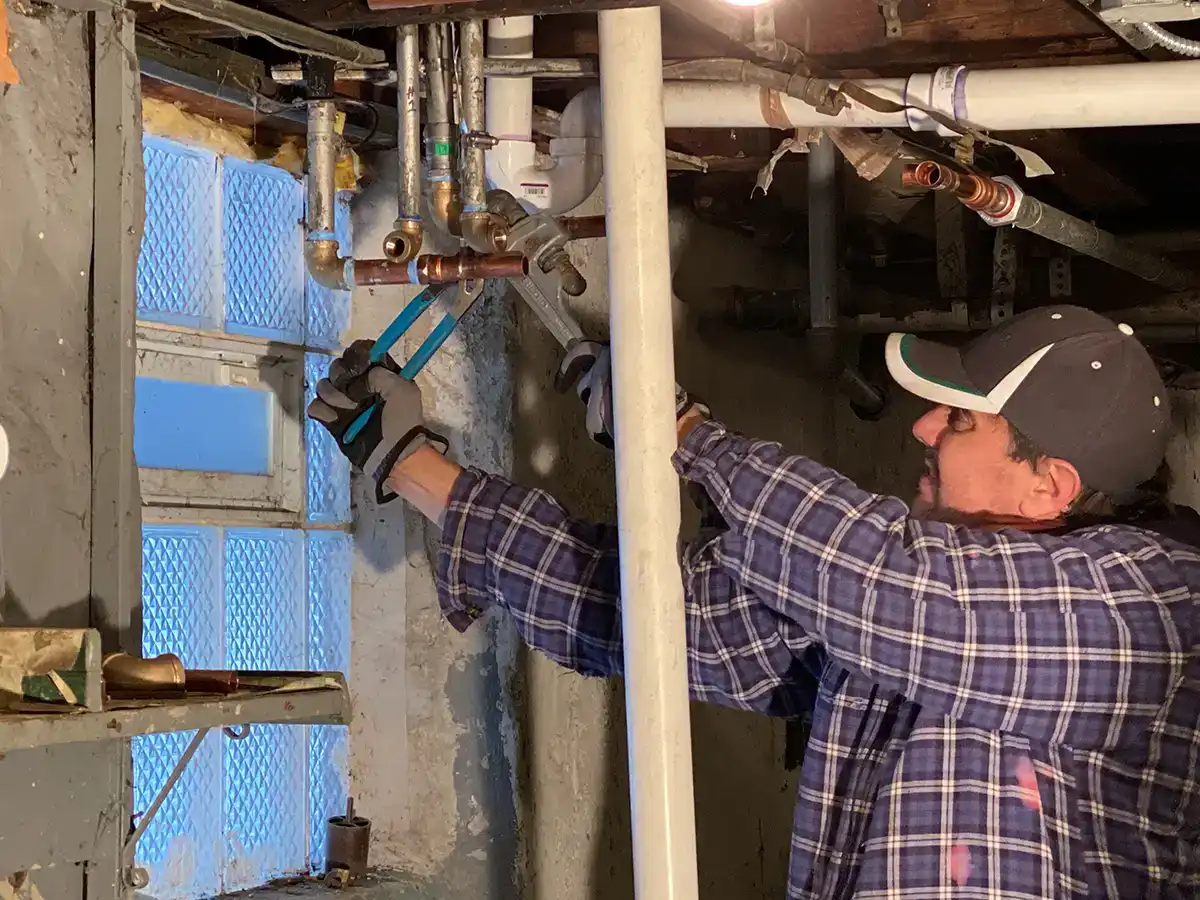professional plumber winterizing a home's plumbing system