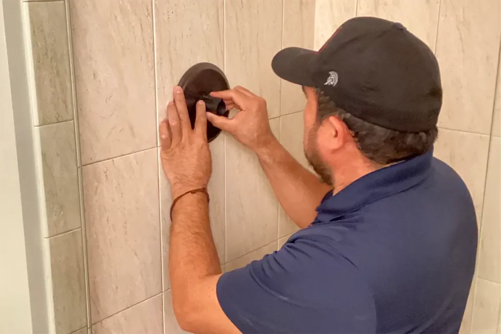 certified plumber repairing a shower