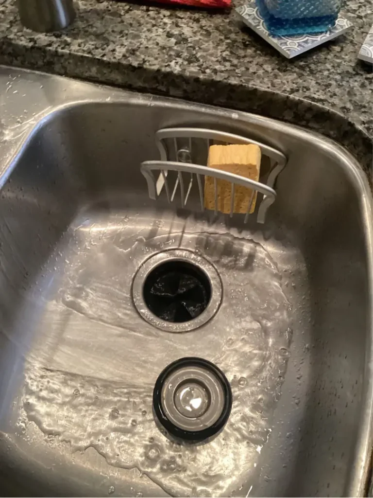 kitchen sink with drain cap to block drain opening