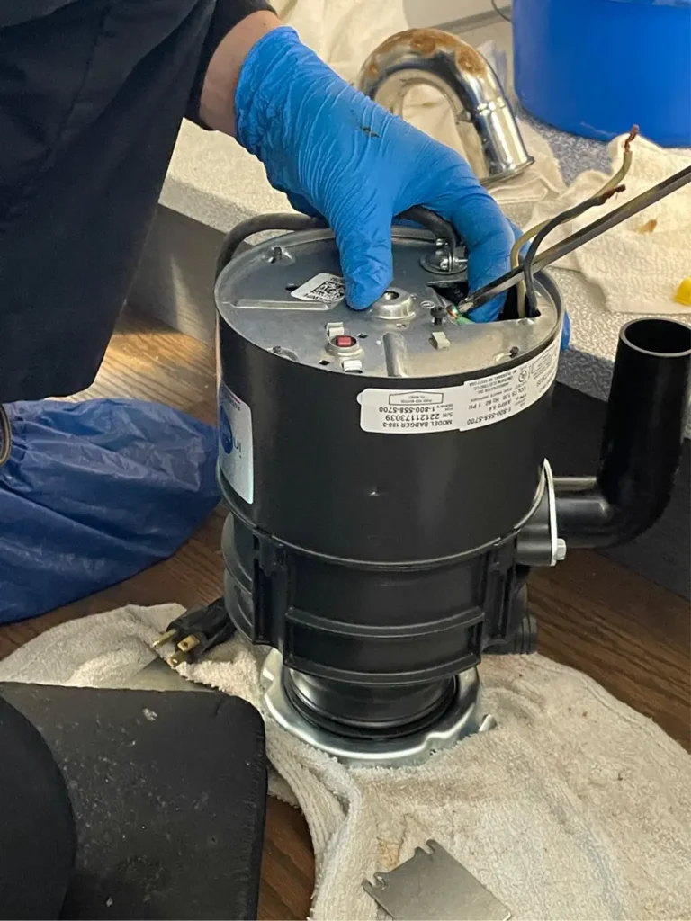 reset button located on bottom of garbage disposal