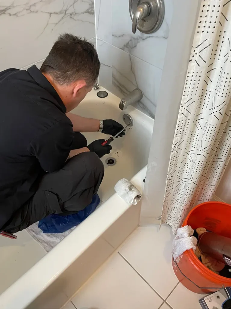 plumber repairing tub faucet 