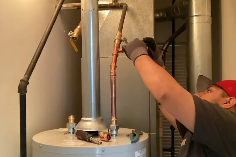 Plumber repairs water heater
