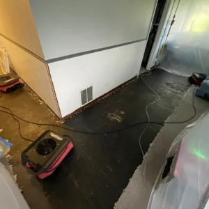 Air movers, dehumidifiers, and air scrubbers drying the restored space