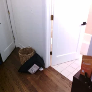Water damage spreading from bathroom to hallway