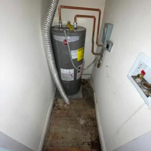 Assessing water damage from a leaking water heater.