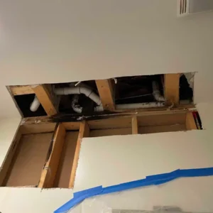 Ceiling access to address the property's plumbing issue.