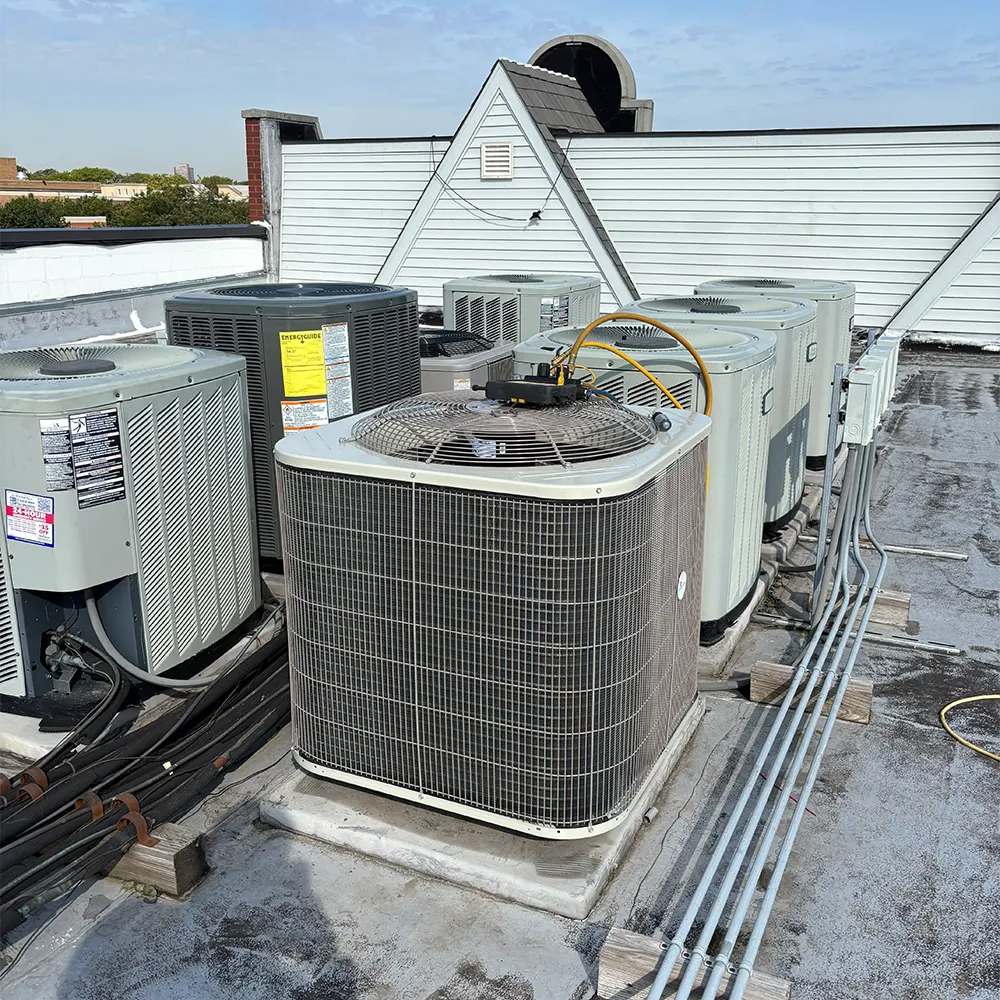 Cluster of rooftop AC condenser units on a Chicago courtyard building