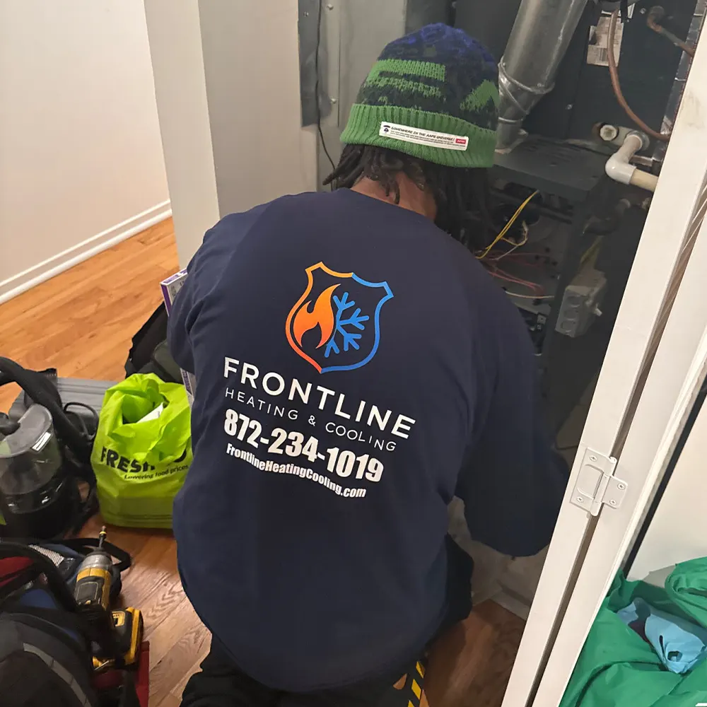 Frontline Heating & Cooling technician diagnosing a furnace on a service call